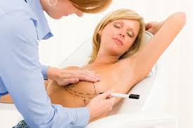 A woman getting her breast drawn 